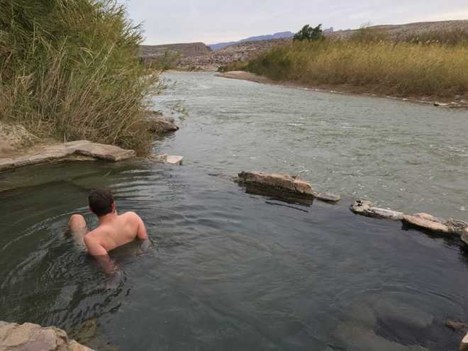 Soaking in a hot spring with the Mexico in the background